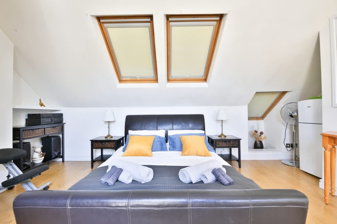Top floor with a king-size bed, ensuite bathroom, desk, and mini fridge—ideal for longer stays or added privacy.