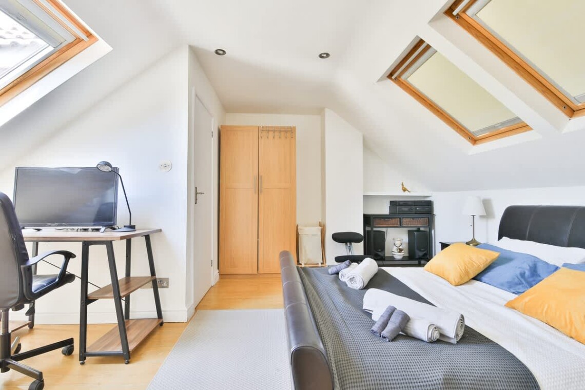 A large, private retreat with a king-size bed, an ensuite bathroom, and a desk